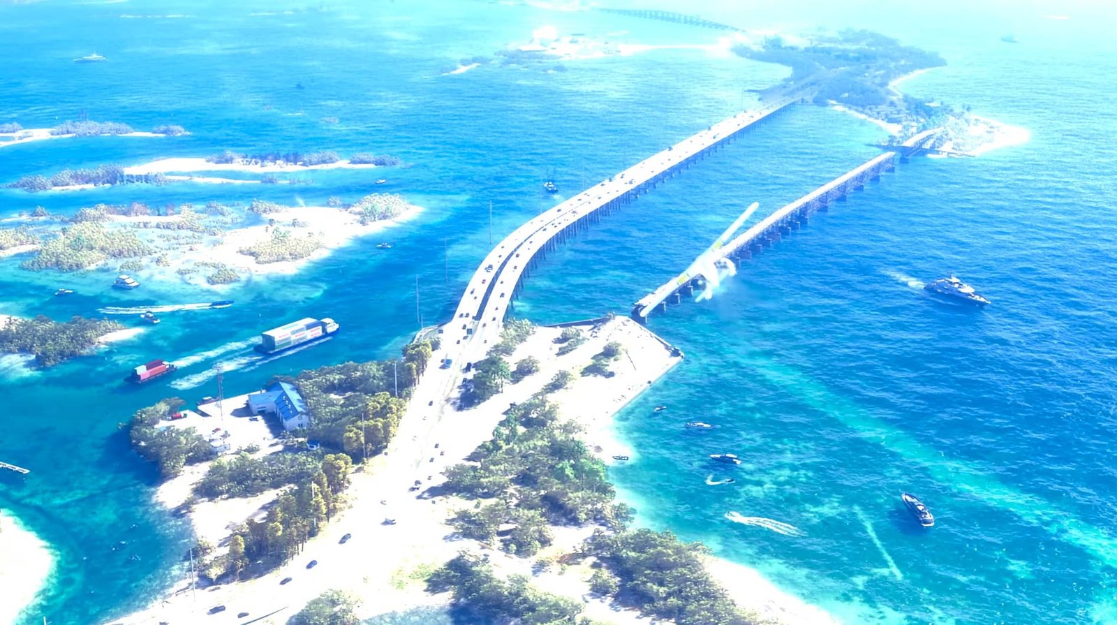 Vista aérea de un puente largo y curvado sobre el océano azul, con pequeñas islas y embarcaciones alrededor.